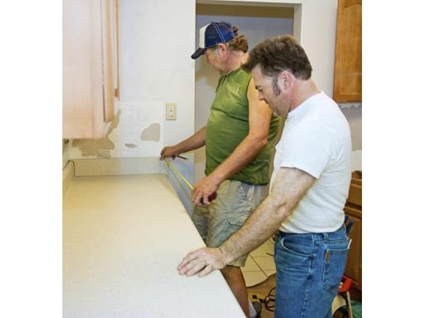 Men measure kitchen counter