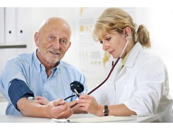 doctor taking man's blood pressure