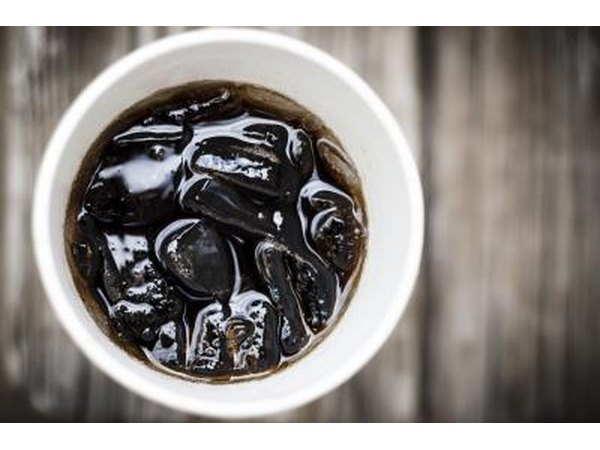A paper cup with cola.