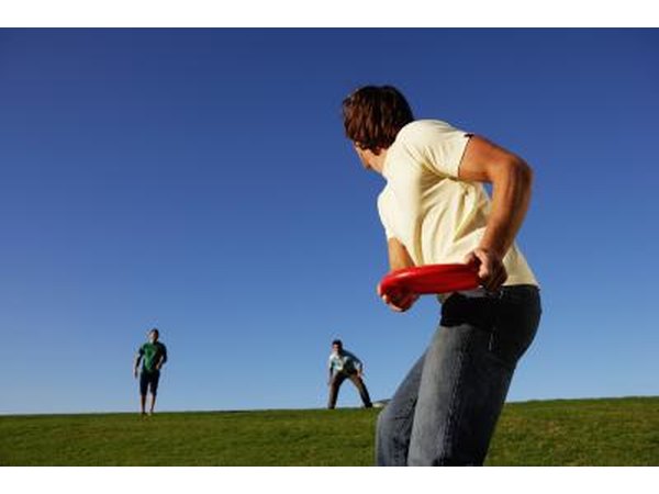 People playing Frisbee on a grassy field.