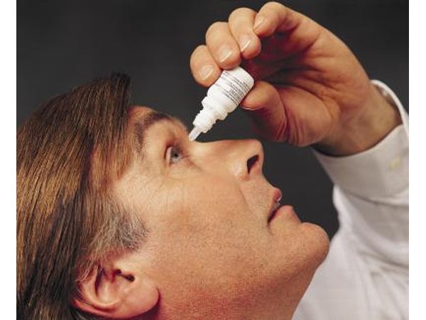 Man using eye drops