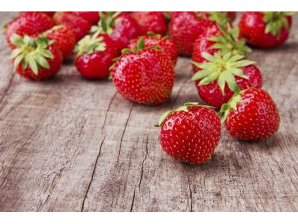 Fresh strawberries on wooden table.
