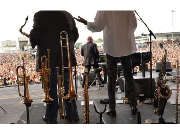 Billy Joel at the piano on stage at a jazz festival in New Orleans.