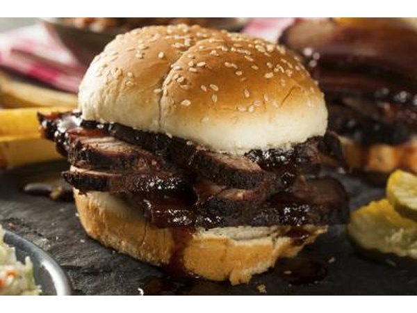 A brisket sandwich with baked beans.