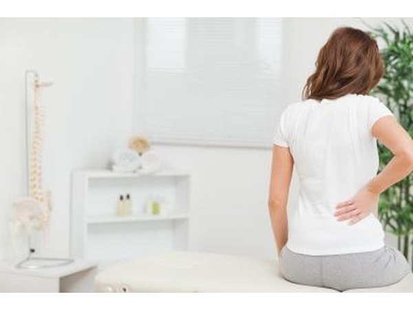 Back pain is the most common symptom.