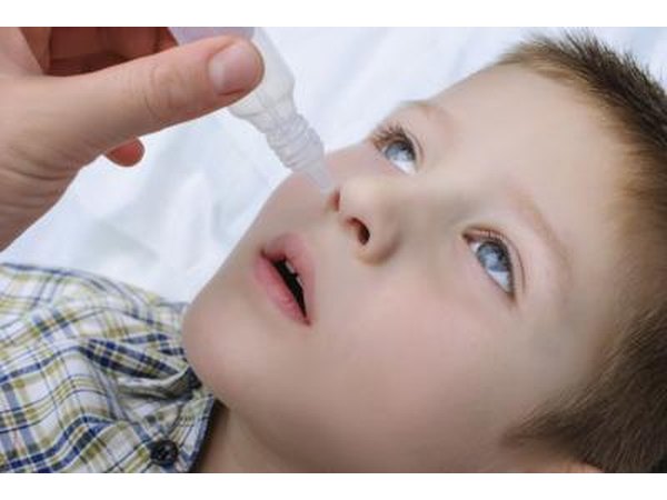 Young boy taking nasal drops