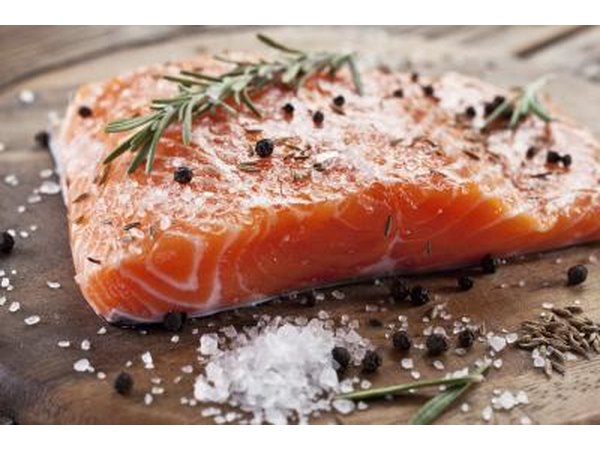 Raw salmon filet with herbs and spices.