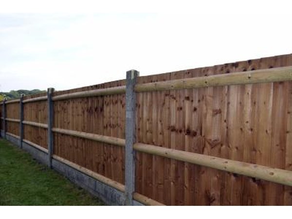 Fence with wooden slats and concrete posts