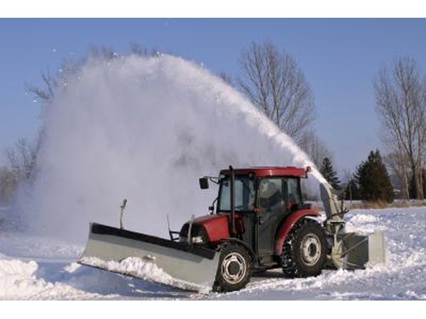 Small vehicle plowing snow