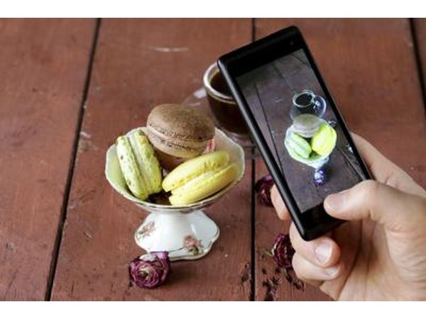 Hand using smartphone to take pictures of cookies
