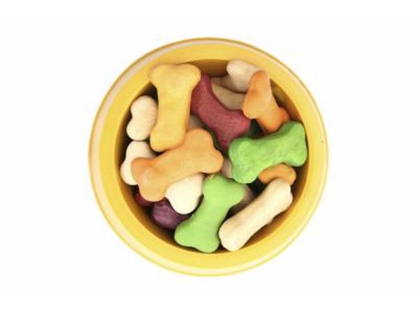 Isolated dog bowl with edible bone treats inside.