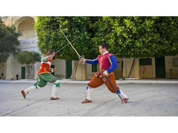 Two men fighting with swords during a performance
