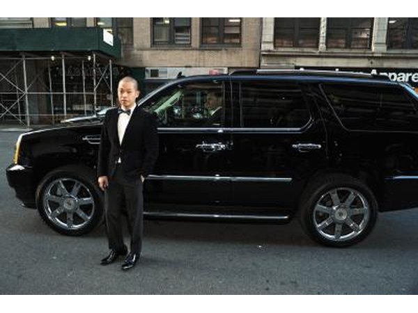 A man standing next to an Escalade