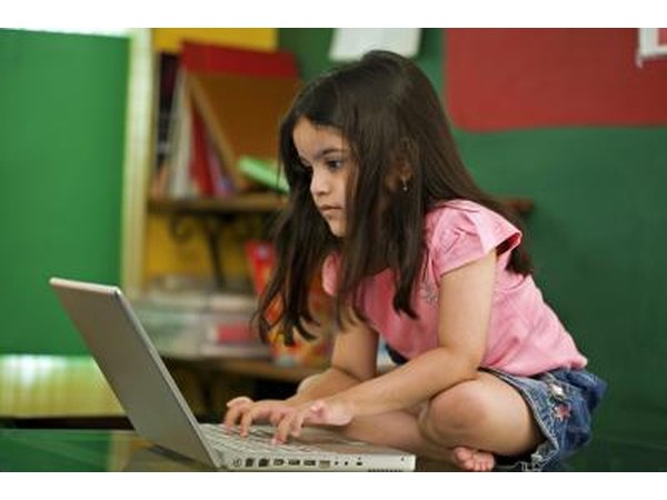 Little girl playing on laptop