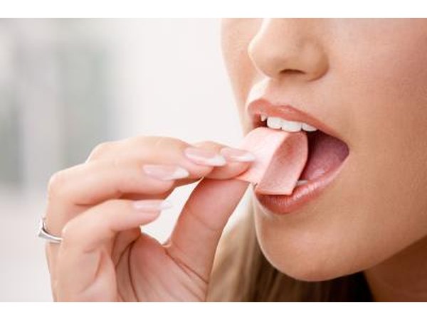 Woman eating a piece of chewing gum