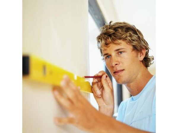Apply tape from the ceiling to the floor directly on each pencil marking