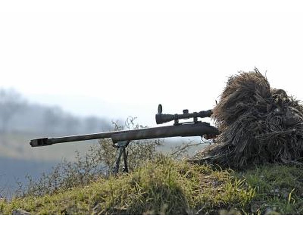 A camouflaged sniper with gun