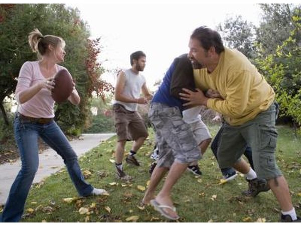 Friends playing football in park