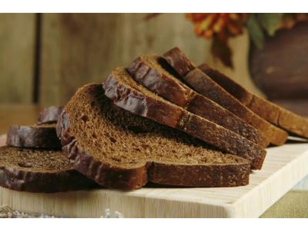 Sliced pumpernickel bread on a cutting board