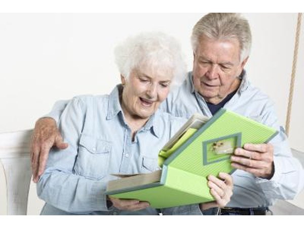 Seniors looking through scrapbook together