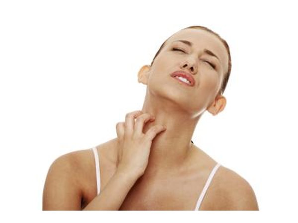 Woman itching from a tick's bite.