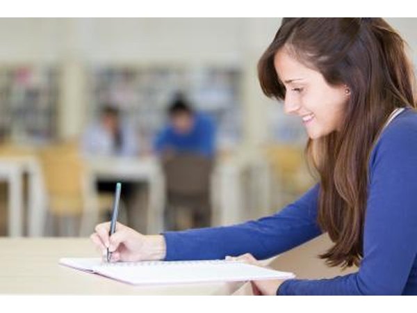 woman taking notes in class