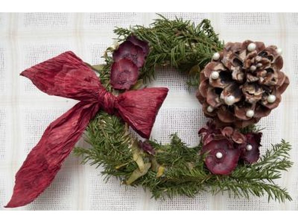 Homemade wreath with ribbon and a pinecone.