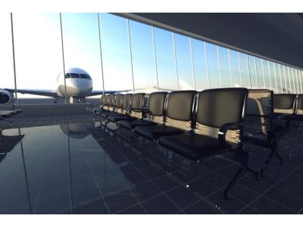 A plane is seen through the window of a modern airport.