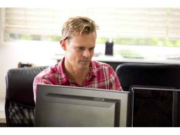Assistant working on two monitors