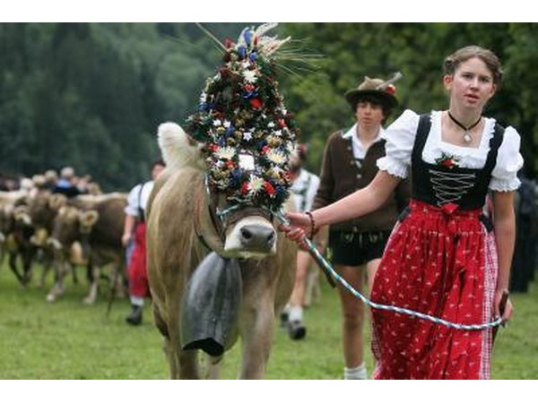 Herdsmen and woman wearing traditional Swiss clothes