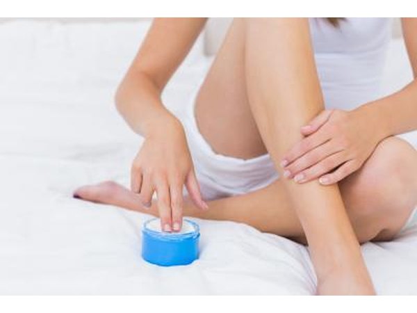 woman applying topical treatment lotion
