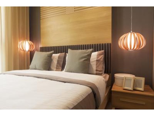 Modern bed with pillows and hanging lamps