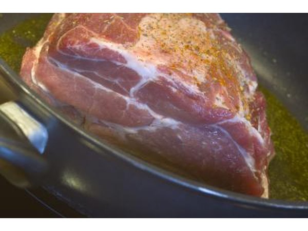 Raw roast pork in a frying pan