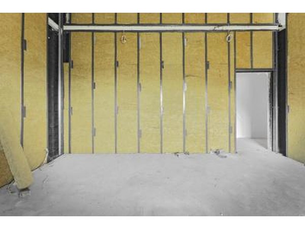 Unfinished building interior, walls covered with sheets of fiberglass
