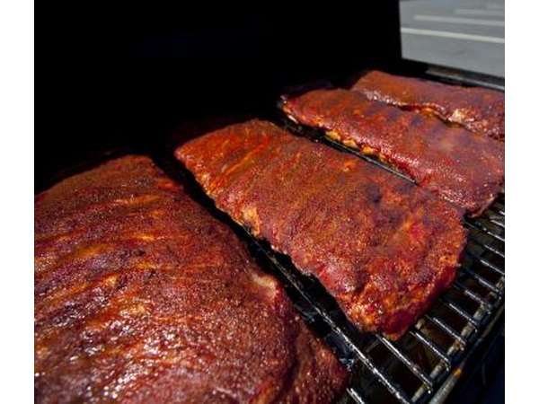 BBQ grill with racks of baby back ribs