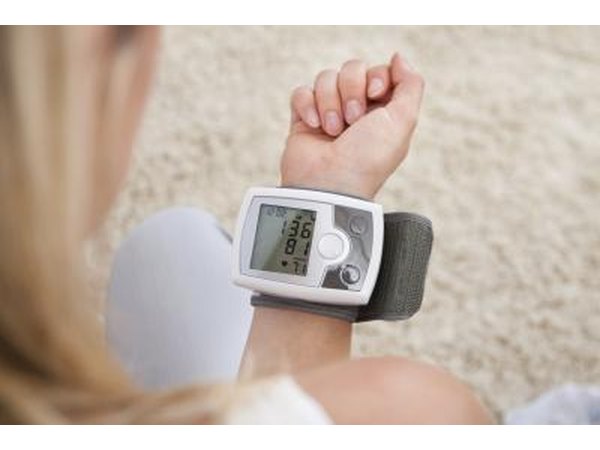 Woman checking heart rate on monitor