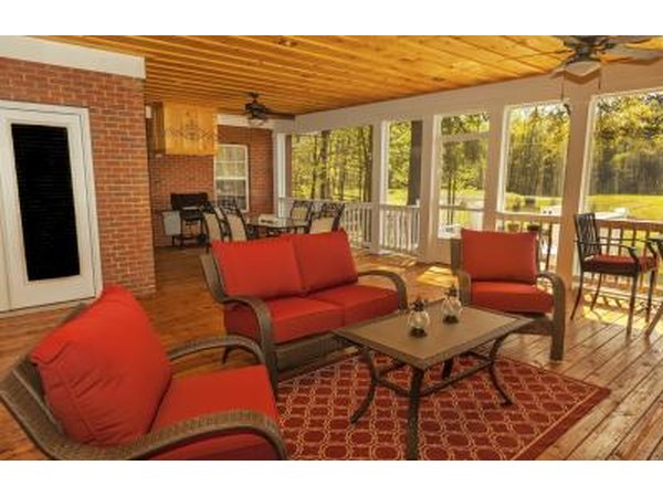A sunroom with honey toned hardwood flooring.