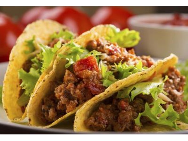 Tacos with lettuce and tomato.