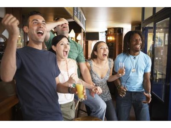 Friends watching football game at bar