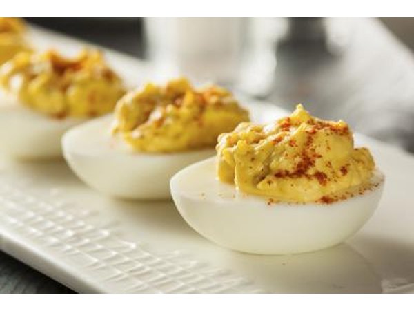 Deviled eggs being served on a modern plate.
