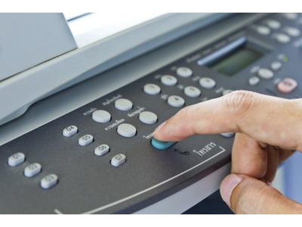 Finger pressing button on fax machine