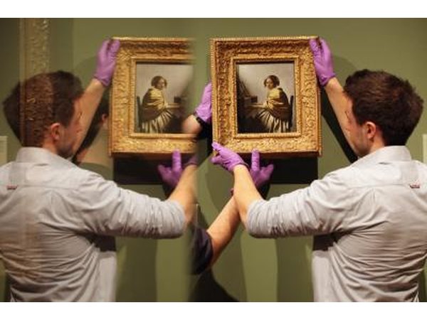 Hanging Vermeer paintings.
