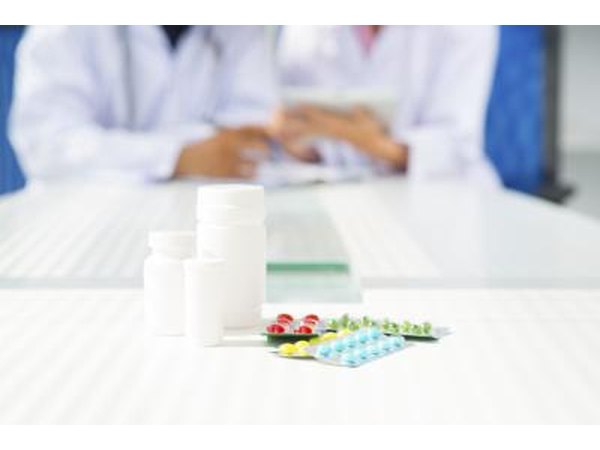 Pills and bottle on table.