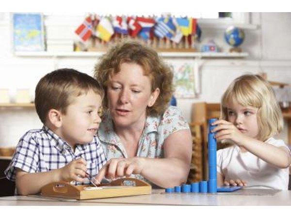 day care worker between two children