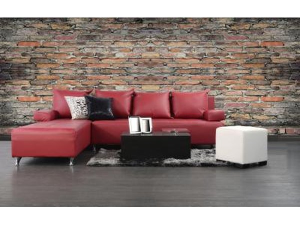 Red leather couch with contrasting block tables and throw pillows.