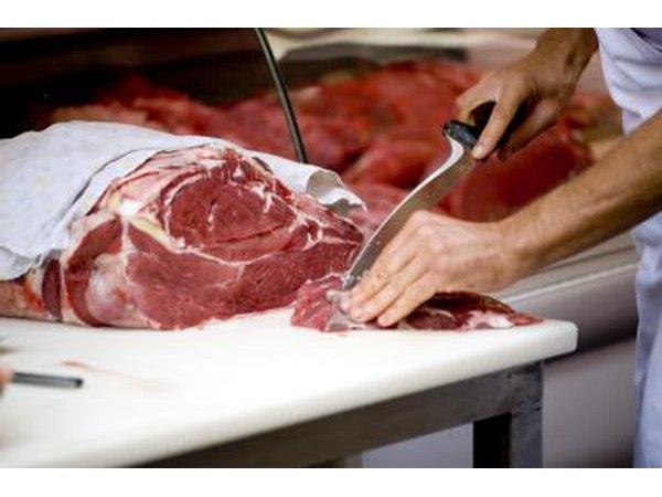 Butcher cutting meat