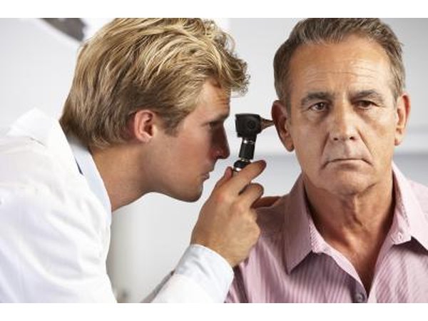 Physician examining patient's ear