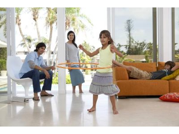 child using hula hoop around waist