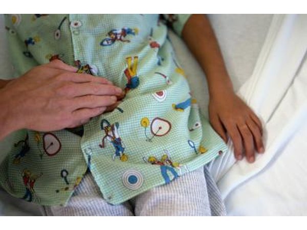 doctor pressing child's stomach