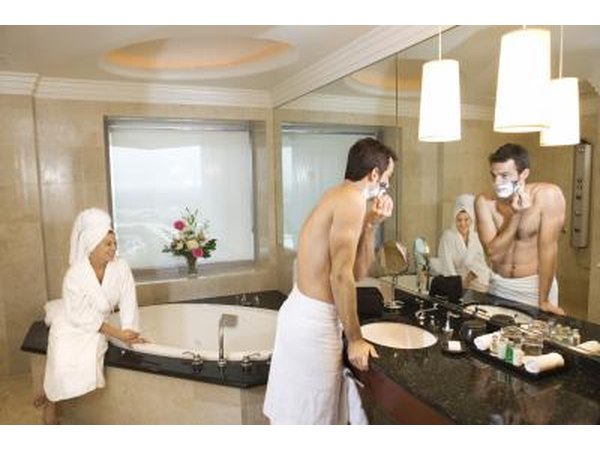 Couple in large hotel bathroom.